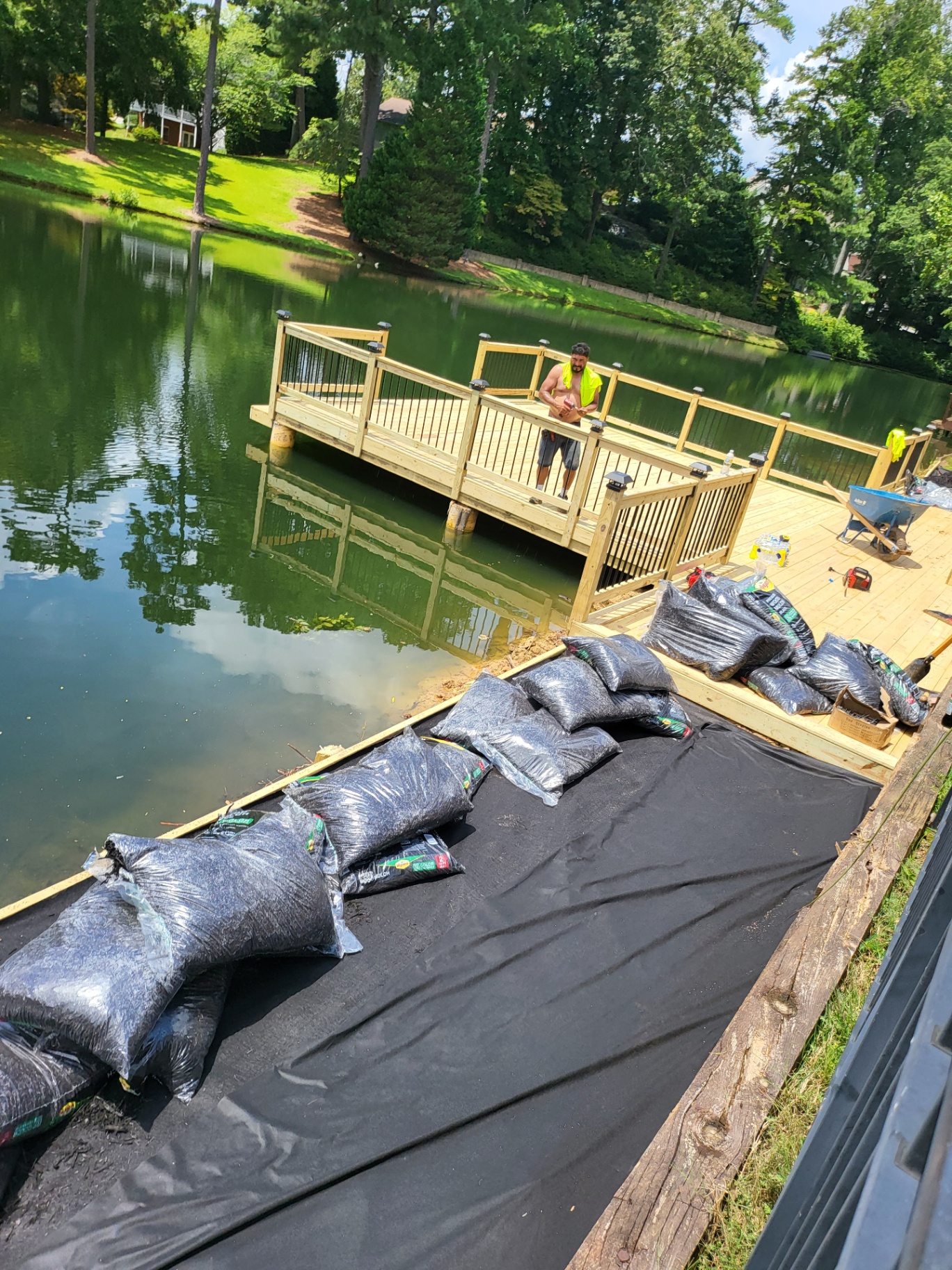 Lakeside dock cleanup with hauled mulch bags